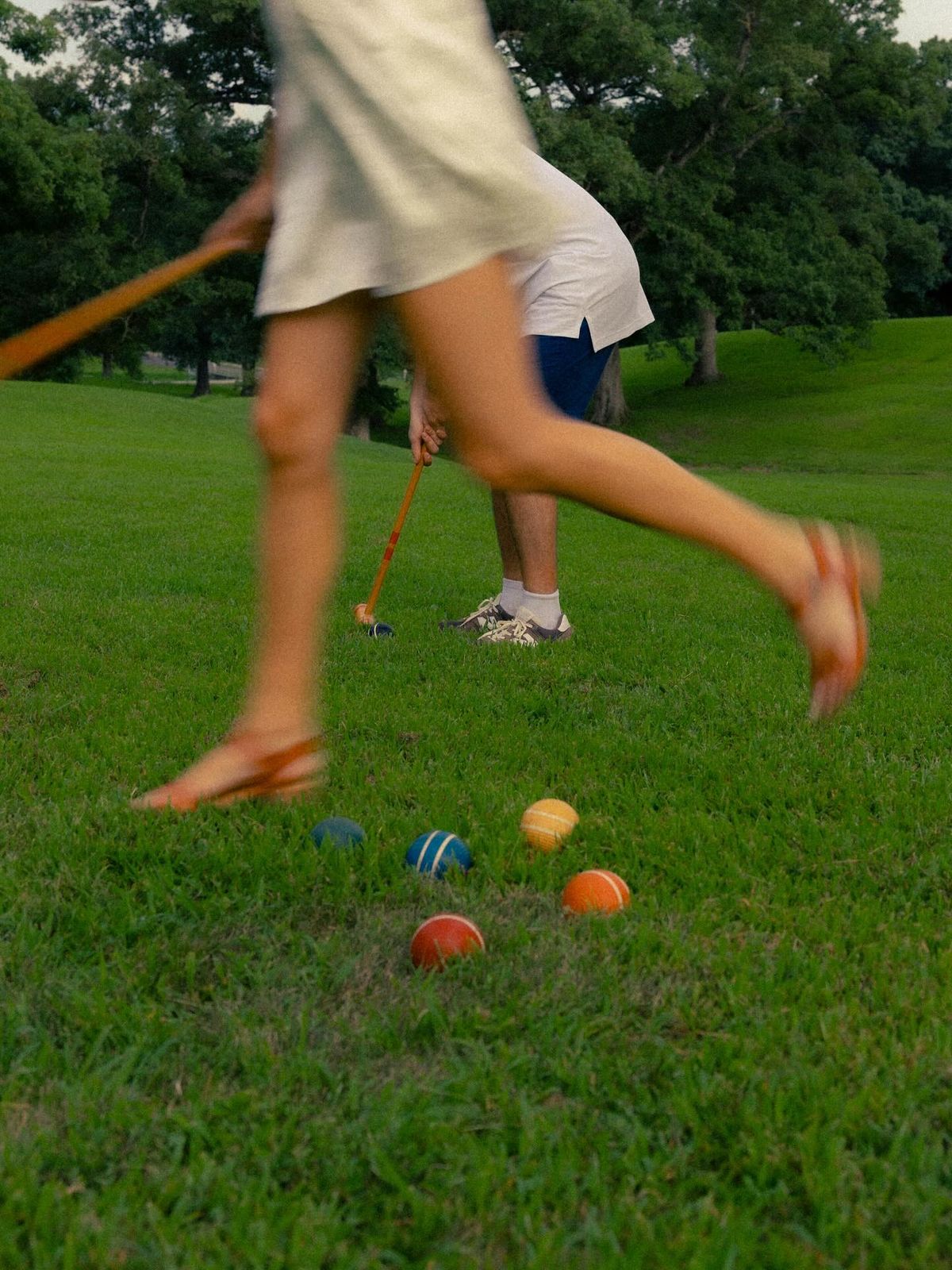 Neighbours playing croquet on a park lawn